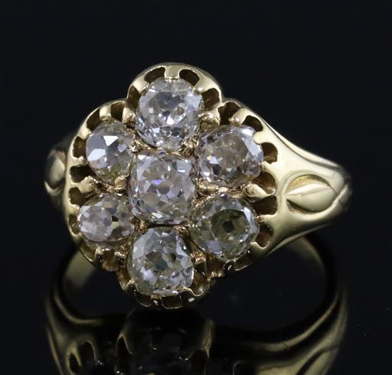 An early-mid 20th century gold and seven stone diamond cluster ring, size I.